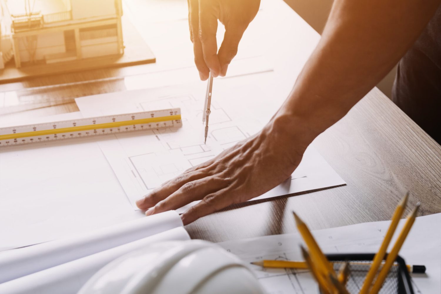 Construction engineer working at blueprint to build large commer